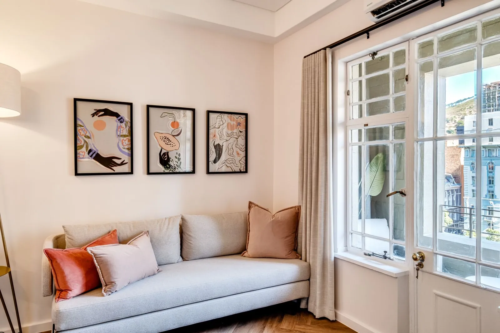 Living room with a sofa by the window onto the balcony